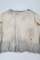 Back flat lay view of the suss knits archive finish raglan sweater showing distressing and dye detail.
