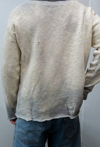 Back view on male model of the archive finish raglan sweater knit in 100% cotton.
