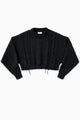 Charcoal black cropped cable knit sweater with distressed hem, chunky hand loomed cotton wool blend knit