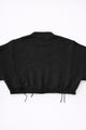 Back view of bright black cropped knit sweater with ribbed hem and subtle distressing