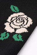 Close-up of red rose intarsia knit detail on black cotton sweater by Suss Knits