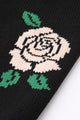 Close-up of red rose intarsia knit detail on black cotton sweater by Suss Knits