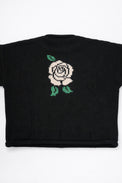 Back of black cotton knit sweater with white rose intarsia design by Suss Knits