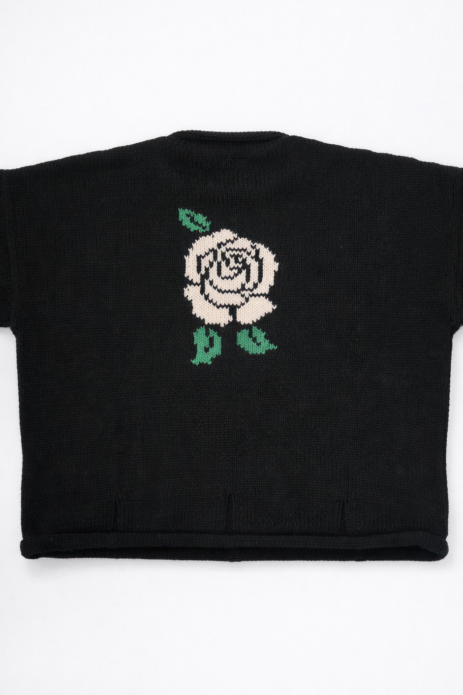 Back of black cotton knit sweater with white rose intarsia design by Suss Knits