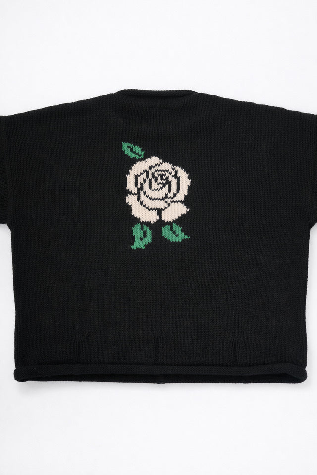 Back of black cotton knit sweater with white rose intarsia design by Suss Knits