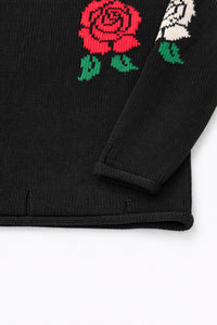 Sleeve and hem detail of black cotton knit sweater with rose intarsia by Suss Knits