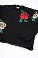 Angle flat lay detail of black cotton knit sweater with rose design by Suss Knits