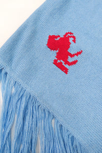 Close-up of knit texture on baby blue recycled cotton poncho with visible weave