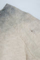Close up of raglan sleeve detail full fashioned with small tattering.