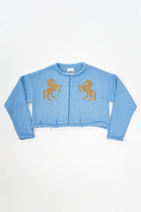 Baby blue cotton cropped knit jacket with tan horse design by Suss Knits front view