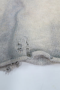 Close up detail of distressing and dye on the suss knits archive finish raglan sweater.