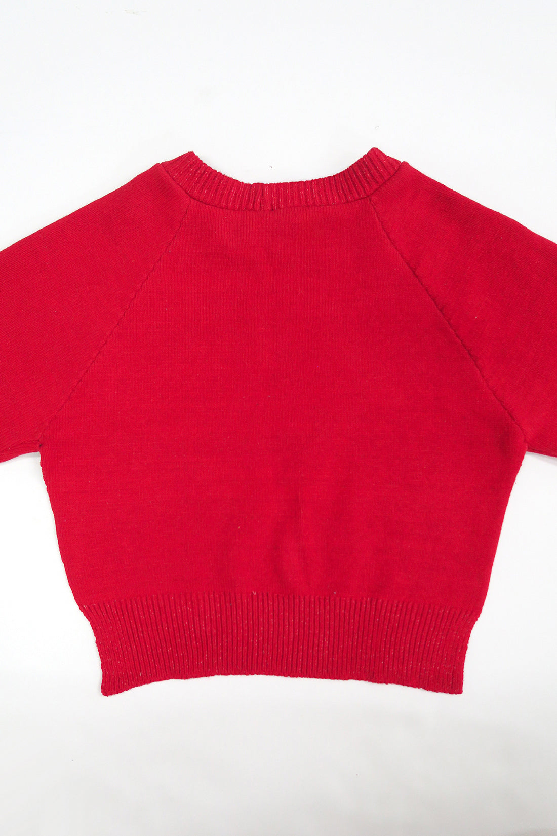 The Suss Knits bright Red Open Raglan Knit Top back panel with ribbed hem