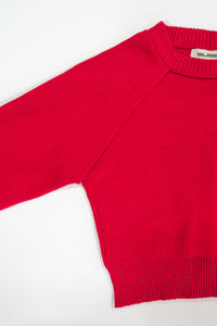 The Suss knits Open Raglan Knit Top in bright red detail photo showing raglan construction and ribbed crewneck