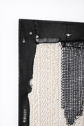 Macro detail of hand lommed cotton yarn corner texture with open stitch pattern in modern abstract textile artwork