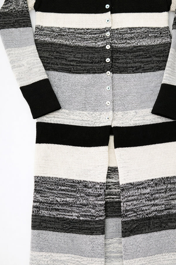 Close-up of hand-sewn shell buttons on striped knit duster cardigan in recycled cotton
