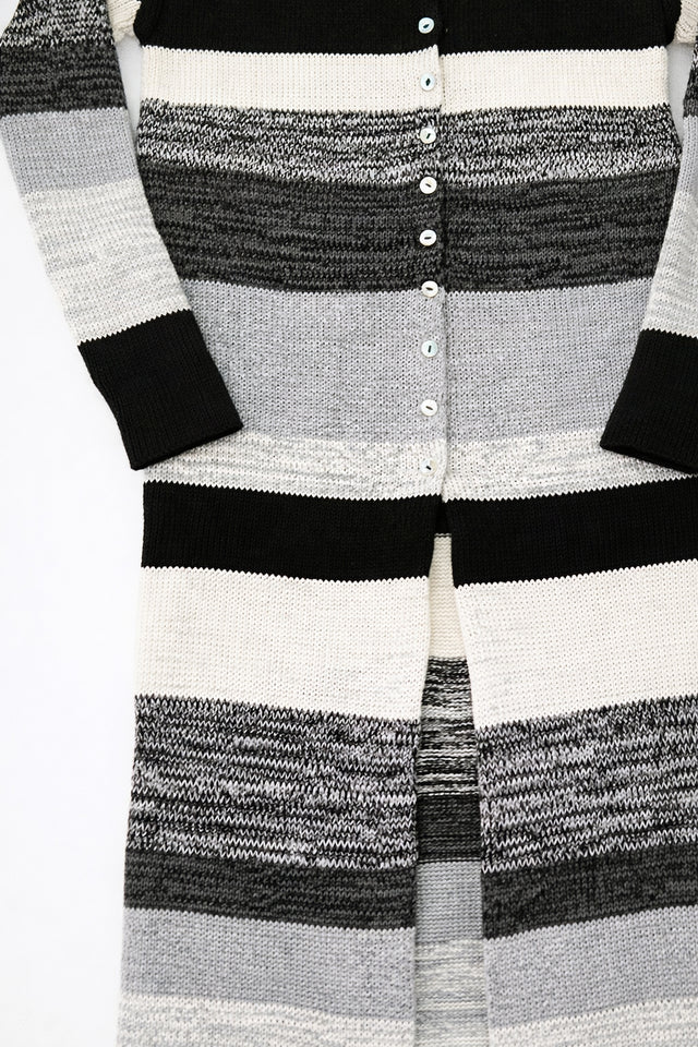 Close-up of hand-sewn shell buttons on striped knit duster cardigan in recycled cotton