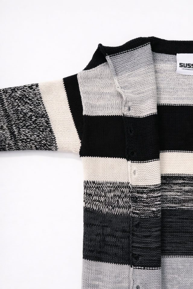 Detail of sleeve and armhole construction on hand-loomed striped cardigan with raw edge finish
