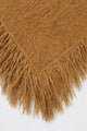 Close-up of texture and long hand-knit fringe on camel fuzzy knit poncho by Suss Knits