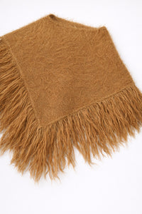 Camel fuzzy knit poncho with fringe shown at an angle by Suss Knits
