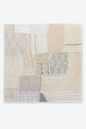 Hand knit textile wall art in cream tones, patchwork fiber art made from cotton, wool and cashmere, featuring cable, rib, lace and seed stitch, handmade in Los Angeles by Suss Knits