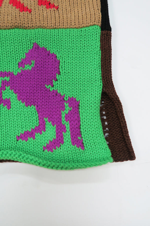 Close-up of horse intarsia knit with raw edge seam and side slit detail