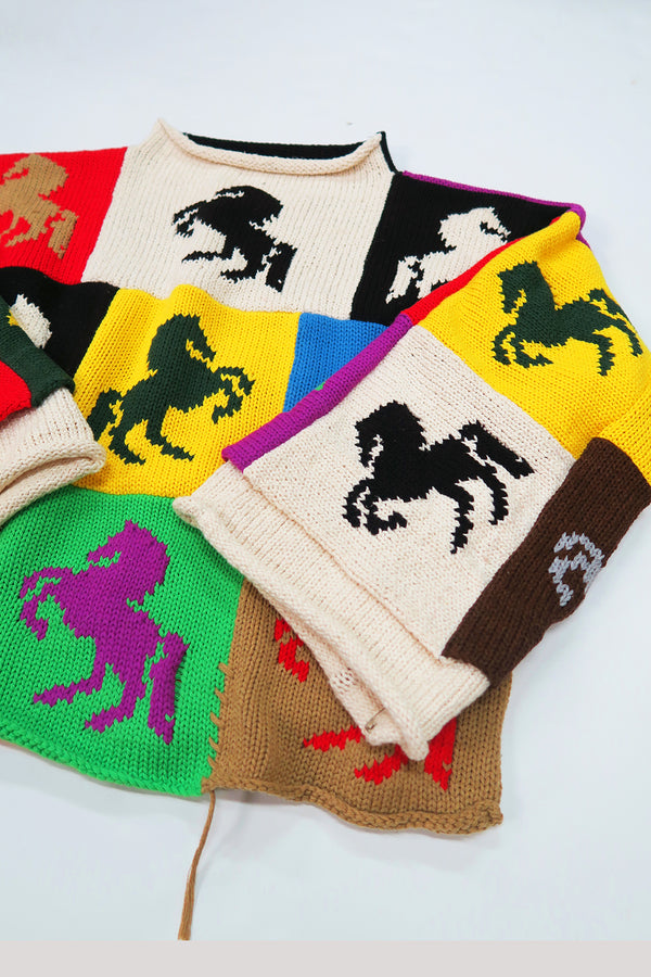 Angled front view of colorful horse intarsia patchwork sweater