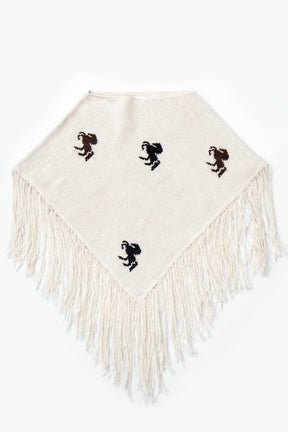 A cropped poncho knit in recycled cotton, cream base with brown and black horse motifs and long fringe