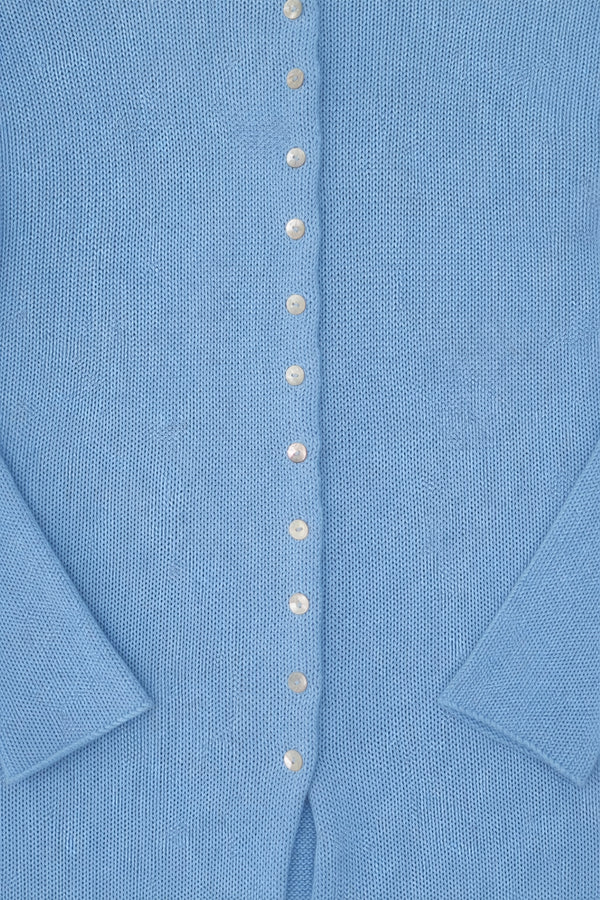 Close-up of shell buttons on light blue recycled cotton knit duster