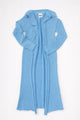 Open front knit duster cardigan in light denim blue with raw edges and long length