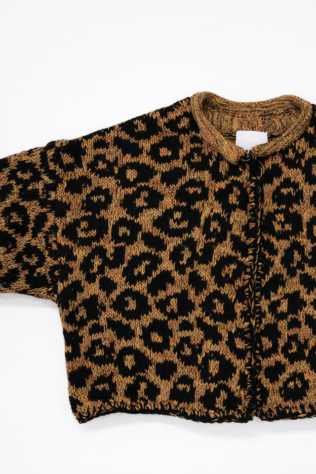 Armhole detail of leopard knit cardigan showing texture and construction