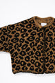 Armhole detail of leopard knit cardigan showing texture and construction
