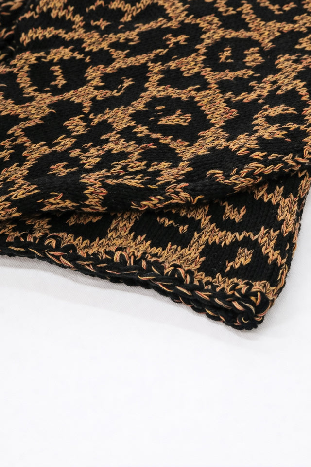 Close-up of tweedy cotton knit texture with black leopard pattern