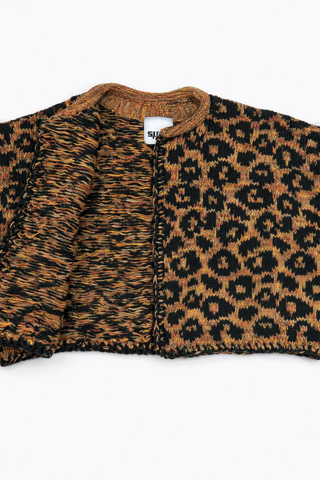 Close-up of leopard knit cardigan neckline with open front showing interior texture