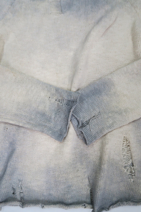 Hand dyed and tattered detail of the archive finish sweater cuff detail.