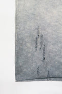 Close-up of hand-distressed knit and raw hem on the Suss Knits Archive Finish Raglan matrix inspired knit with grey hand dye technique