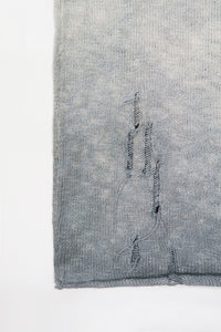 Close-up of hand-distressed knit and raw hem on the Suss Knits Archive Finish Raglan matrix inspired knit with grey hand dye technique