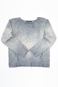 Front flat lay photo of the suss knits distressed finish archive sweater that is hand dyed in grey tones and knit in a cotton slub yarn.