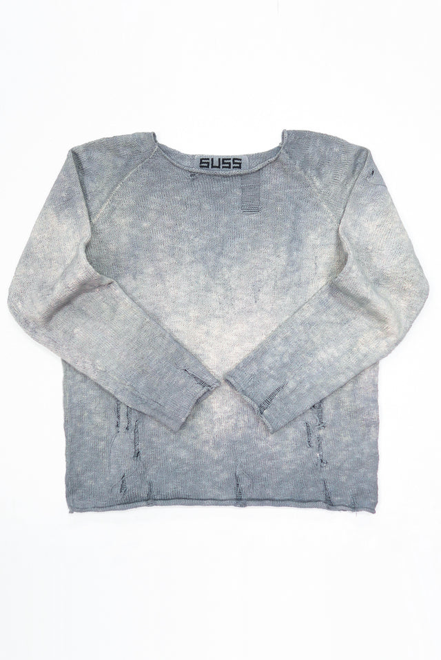 Front flat lay photo of the suss knits distressed finish archive sweater that is hand dyed in grey tones and knit in a cotton slub yarn.