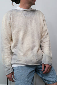 Male model in the suss knits archive finish raglan sweater knit in 100% cotton and finished with distressing and hand dye techniques, hand loomed in los angeles.