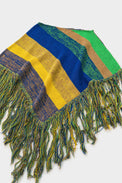 Angled view of striped hand loomed poncho with fringe detail in recycled cotton