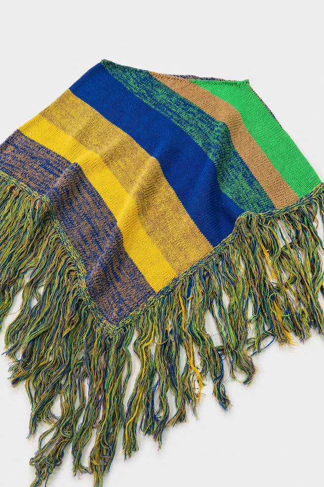 Angled view of striped hand loomed poncho with fringe detail in recycled cotton
