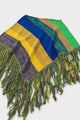 Angled view of striped hand loomed poncho with fringe detail in recycled cotton
