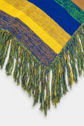 Detailed view of multicolor fringe on hand loomed striped poncho in recycled cotton