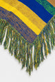 Detailed view of multicolor fringe on hand loomed striped poncho in recycled cotton