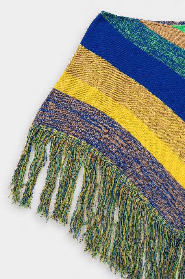 Left side view of striped hand loomed poncho with fringe detail in recycled cotton