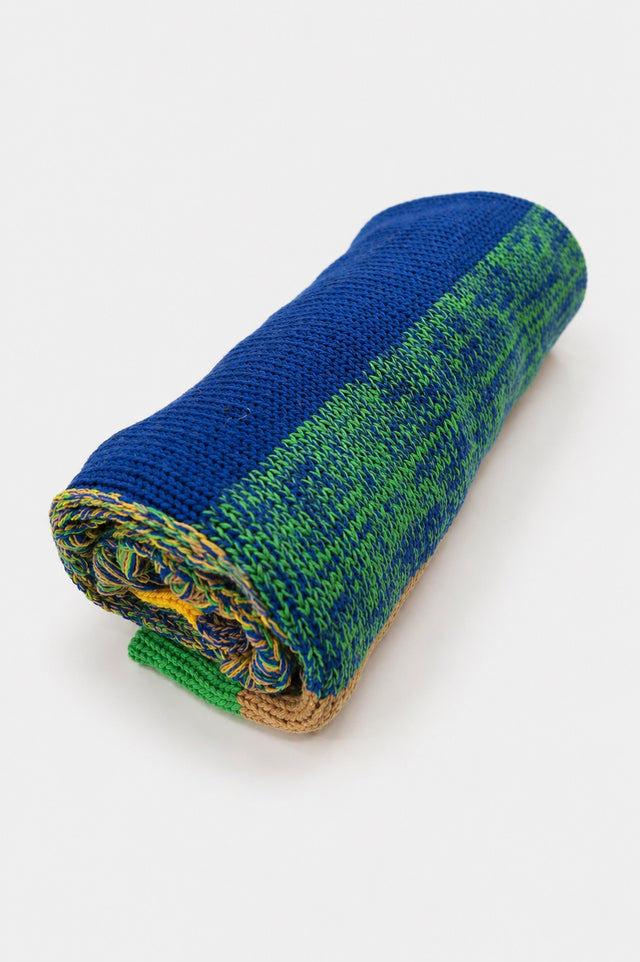 Rolled striped poncho showing knit texture and color variation in recycled cotton