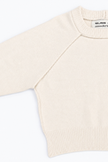 A close up of the Suss Cream Open Raglan Knit Top detail showing raglan construction and ribbed crewneck knit in cotton