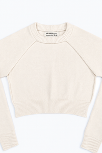 The Suss Knits Cream Open Raglan Knit Top front detail with open sides and raglan sleeves with view of ribbed neckline in cotton