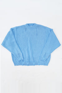 Oversized blue knit sweater flatlay by Suss Knits with wide fit and distressed ribbed hem