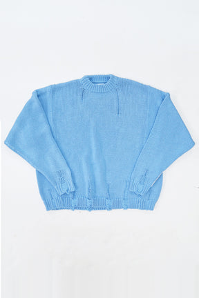 Oversized blue knit sweater flatlay by Suss Knits with wide fit and distressed ribbed hem